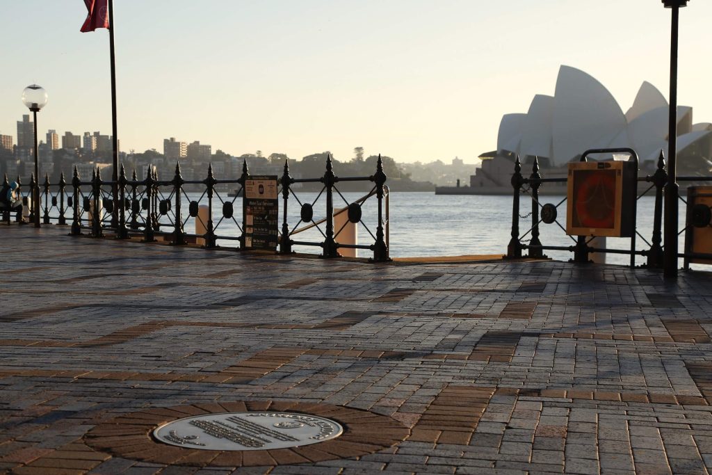 A plaque on the Sydney Writers Walk at Circular Quay with the Sydney Opera House in the background